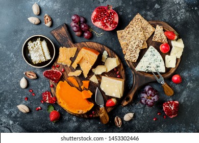 Cheese variety board or platter with cheese assortment, grapes, honey and nuts. Black stone background. Top view, flat lay - Powered by Shutterstock