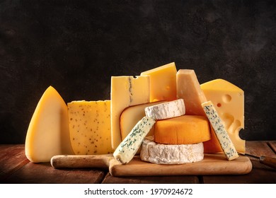 Cheese variety on dark rustic backgrounds. Soft and hard cheeses - Powered by Shutterstock