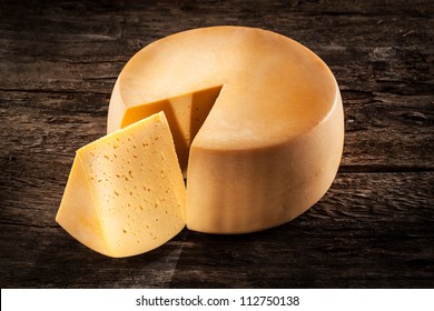 Cheese wheel on wood. Organic food