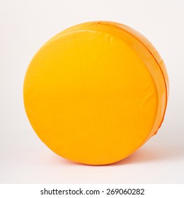 cheese wheel in vacuum packed on white background