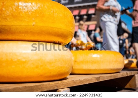 Cheese wheels on display on a summer day at the regular famous Dutch cheese market in Gouda Netherlands where farmers and vendors sell local produce to consumers and companies Stock photo © 