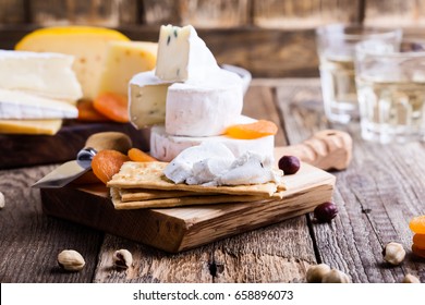 Cheese And Wine Party  Table, Perfect Holiday Appetizer On Rustic Wooden Board, Goat Cheese With  Crackers 