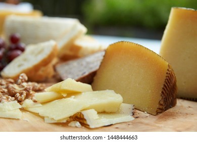 Cheeseboard with grapes nuts cheese and bread