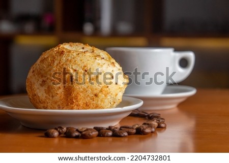 Cheesebread with cup of coffee and coffee beans