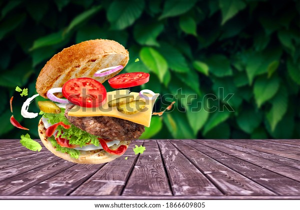 Cheeseburger\
with flying ingredients on summer\
background