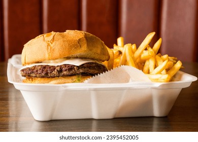 Cheeseburger and fries in a takeout container - Powered by Shutterstock