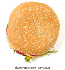 Cheeseburger And Mustard In Sesame Seeded Bun Isolated On White From Overhead.