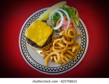 Cheeseburger On A Kaiser Roll With Curly Fries On The Side