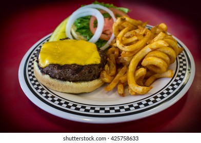 Cheeseburger On A Kaiser Roll With Curly Fries On The Side