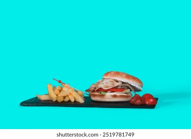 A cheeseburger with onions and crispy French fries is a classic comfort food. Served on a slate plate, its mouthwatering presentation makes it ideal for food photography. Popular among foodies, this s - Powered by Shutterstock