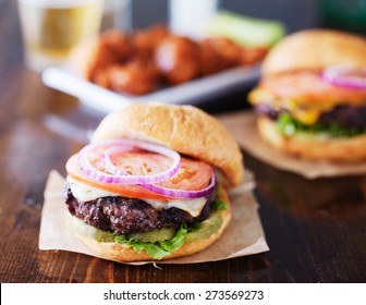 cheeseburgers with wings and beer - Powered by Shutterstock