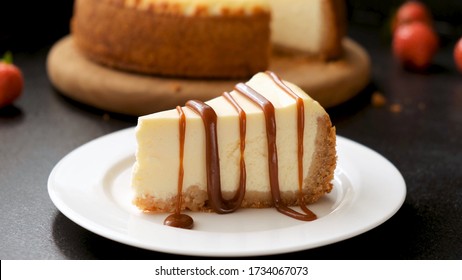 Cheesecake with caramel sauce on black background. Tasty homemade caramel cheesecake