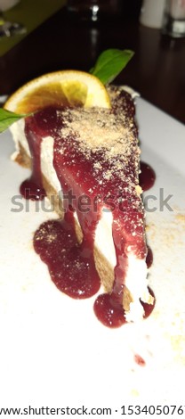 Cheesecake decorated portion on table, a delirious tasty cheese cake