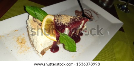 Cheesecake decorated portion on table, a delirious tasty cheese cake