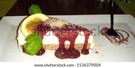 Cheesecake decorated portion on table, a delirious tasty cheese cake