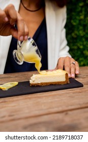 Cheesecake Lemon Berry Woman Pouring Sauce Food Styling Wooden Table 