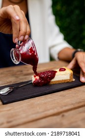 Cheesecake Lemon Berry Woman Pouring Sauce Food Styling Wooden Table 