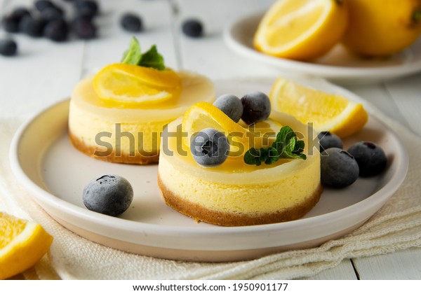 Cheesecake lemon\
tart cake or pie, with fresh lemon,blueberry and mint. White\
background, lifestyle healthy sweet\
food