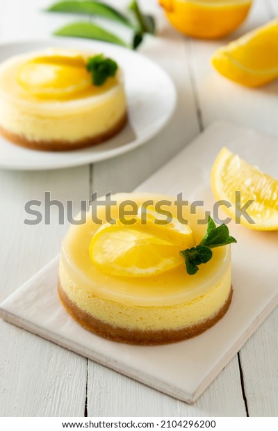 Cheesecake lemon
tart cake or pie, with fresh lemon and mint. White background,
lifestyle healthy sweet
food