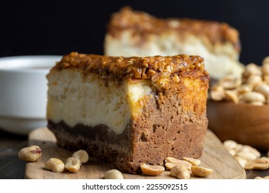 Cheesecake made of soft fresh cheese and peanuts in salted caramel, sweet combined dessert cut into pieces - Shutterstock ID 2255092515