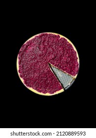 Cheesecake pie covered with raspberry isolated on a dark background. Missing slice from the pie. Sweet dessert.