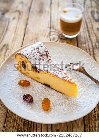 Cheesecake with raisins on wooden table
