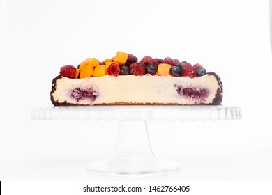 cheesecake with raspberries and blueberries. Half cake cut on white background. - Powered by Shutterstock