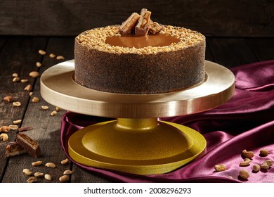 Cheesecake With Salted Caramel, Peanuts And Chocolate Bar