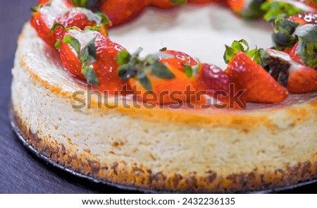 Cheesecake with strawberry on plate, close up, decorated, minimal. Homemade berry cheesecake. For birthday, party, pastry confectionery advert