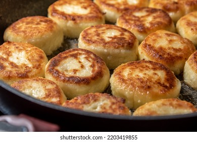 Cheesecakes Or Syrniki On A Pan. Russian And Ukrainian Cuisine