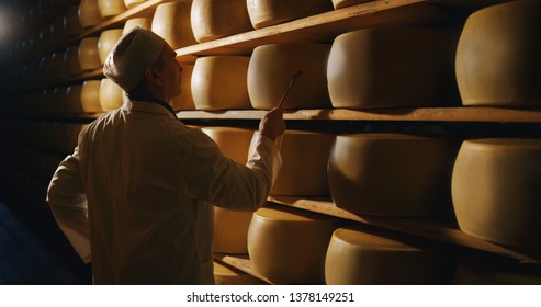 https://image.shutterstock.com/image-photo/cheesemaker-controlling-seasoning-lots-wheels-260nw-1378149251.jpg