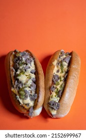 Cheesesteak With Cheese Sauce And Sweet Pickle Relish, Closed Up Orange Background