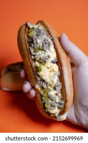 Cheesesteak With Cheese Sauce And Sweet Pickle Relish, Closed Up Orange Background