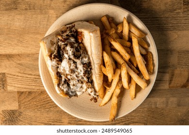 Cheesesteak with French fries on a plate