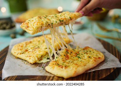 Cheesy Garlic Bread On Wooden Board