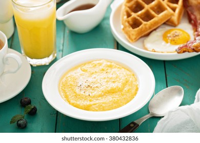 Cheesy Grits With Butter In A White Bowl For Breakfast