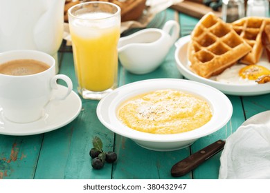 Cheesy Grits With Butter In A White Bowl For Breakfast