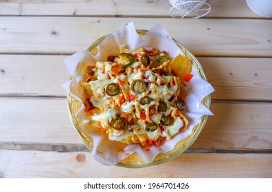 Cheesy Nachos On Wooden Background