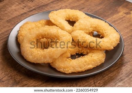 Cheesy Shrimp Doughnut or Shrimp tempura fried donuts on black plate on wooden background.