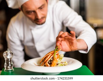 Chef Adding Final Touch To Delicious Baked Salmon