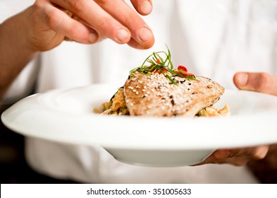 Chef Adding Final Touch To Tuna Appetizer