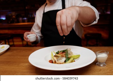 Chef Is Adding Fried Onion Chips To A Fish Dish