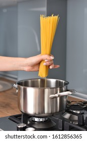 Chef adding spaghetti into pan
