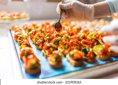 Chef adding special dressing on colored canapes - Powered by Shutterstock