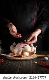 Chef Adds Red Viburnum To The Broiler Chicken Before Roasting. Cooking National Dishes In The Kitchen Of The Restaurant