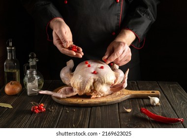 Chef Adds Red Viburnum To The Broiler Chicken Before Roasting. Cooking National Dishes In The Kitchen Of The Restaurant