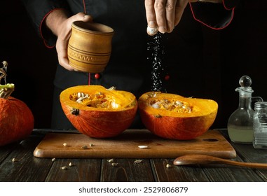 A chef adds salt to a cut ripe pumpkin on the kitchen counter before roasting. The concept is a low-key fruit diet or a national pumpkin dish. - Powered by Shutterstock