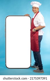 Chef With Big Phone. App Recommendation By Cook. Chef Man And Mock Up Smartphone. Phone In Front Of Cafe Chef. Cafe Worker In Cook Clothes. Restaurant Website Template. Baker With Smartphone Smiling