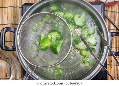Chef boiling Broccoli in pan  / cooking spicy spaghetti concept