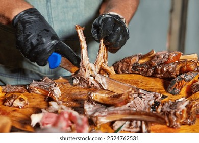 A chef carefully slicing a lamb rack on a wooden board, garnished with herbs and vegetables for a flavorful presentation. - Powered by Shutterstock